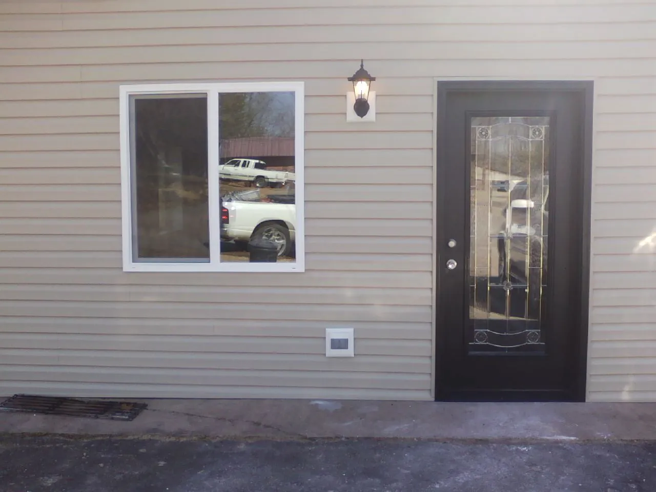 New siding, window and entry door on the side of an addition in Garden Plain